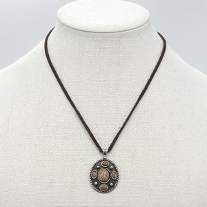 Necklace with leather cord and silver pendant.